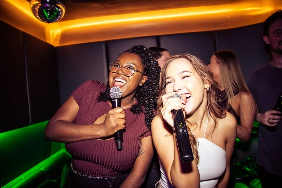 ladies singing karaoke in lucky voice bar