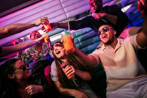 group of people having drinks at karaoke