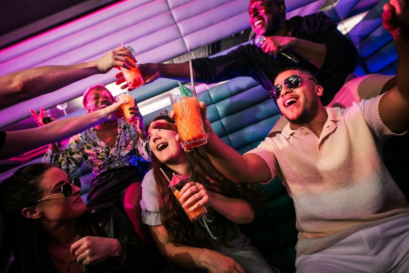 group of people having drinks at karaoke